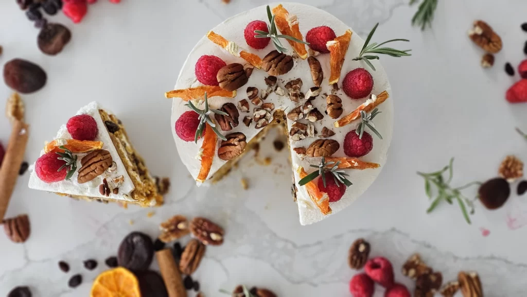 Top View of Our Sliced Single-Tier Carrot Cake with Raspberry, Pecan, and Orange Accents from our Celebration Cake Gallery