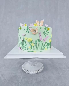 Celebrate with this charming green birthday cake adorned with fondant decorations.
