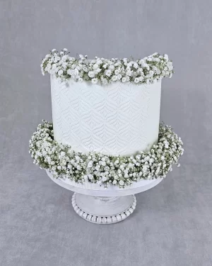 Elegant Tall Cake with White Flower Decorations Elegant Tall Cake with White Flower Decorations and Stencil Art